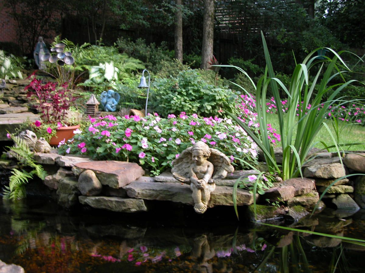 Statuette around a landscaped Koi pond.