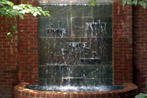 A unique water feature featuring a water fall in landscape design.